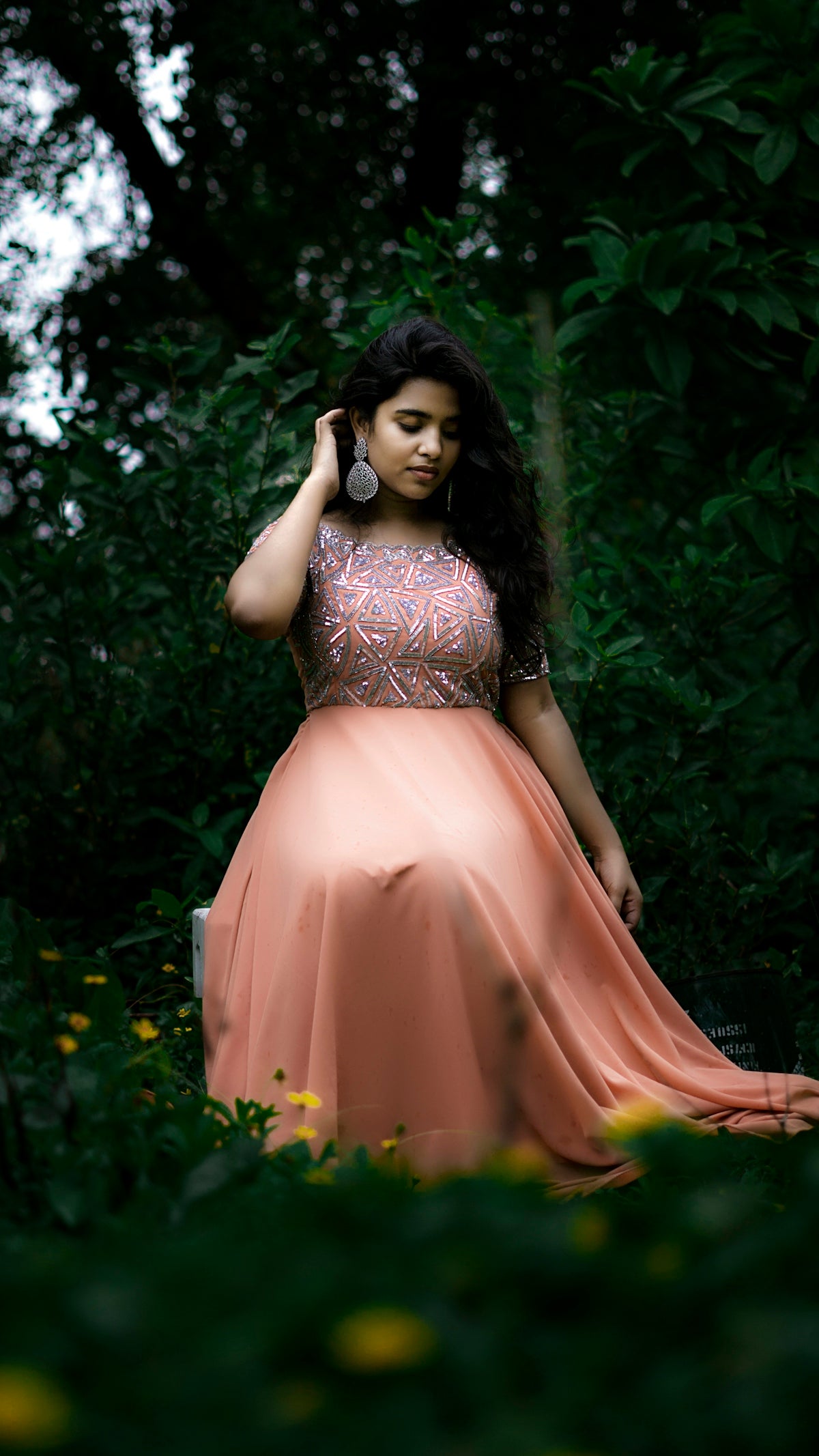 woman in brown dress standing near green leaf plant