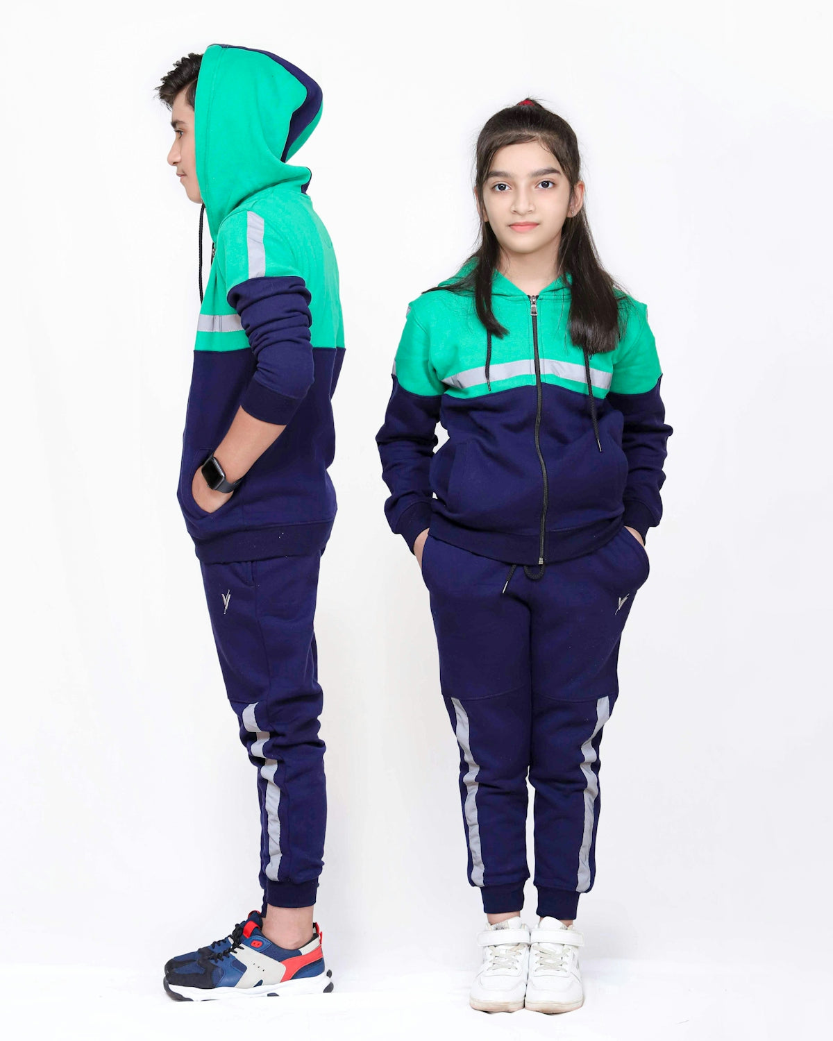 a young girl and boy in matching tracksuits