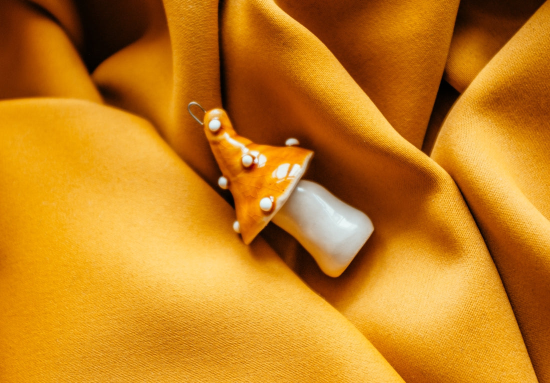 a yellow fabric with a star brooch on it