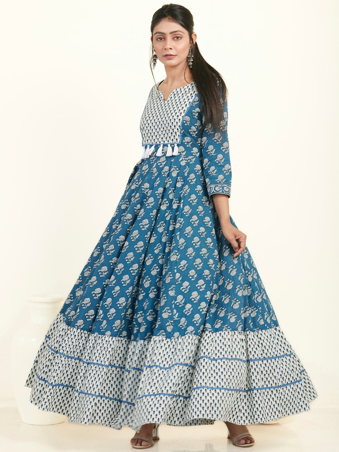 a woman in a blue and white dress