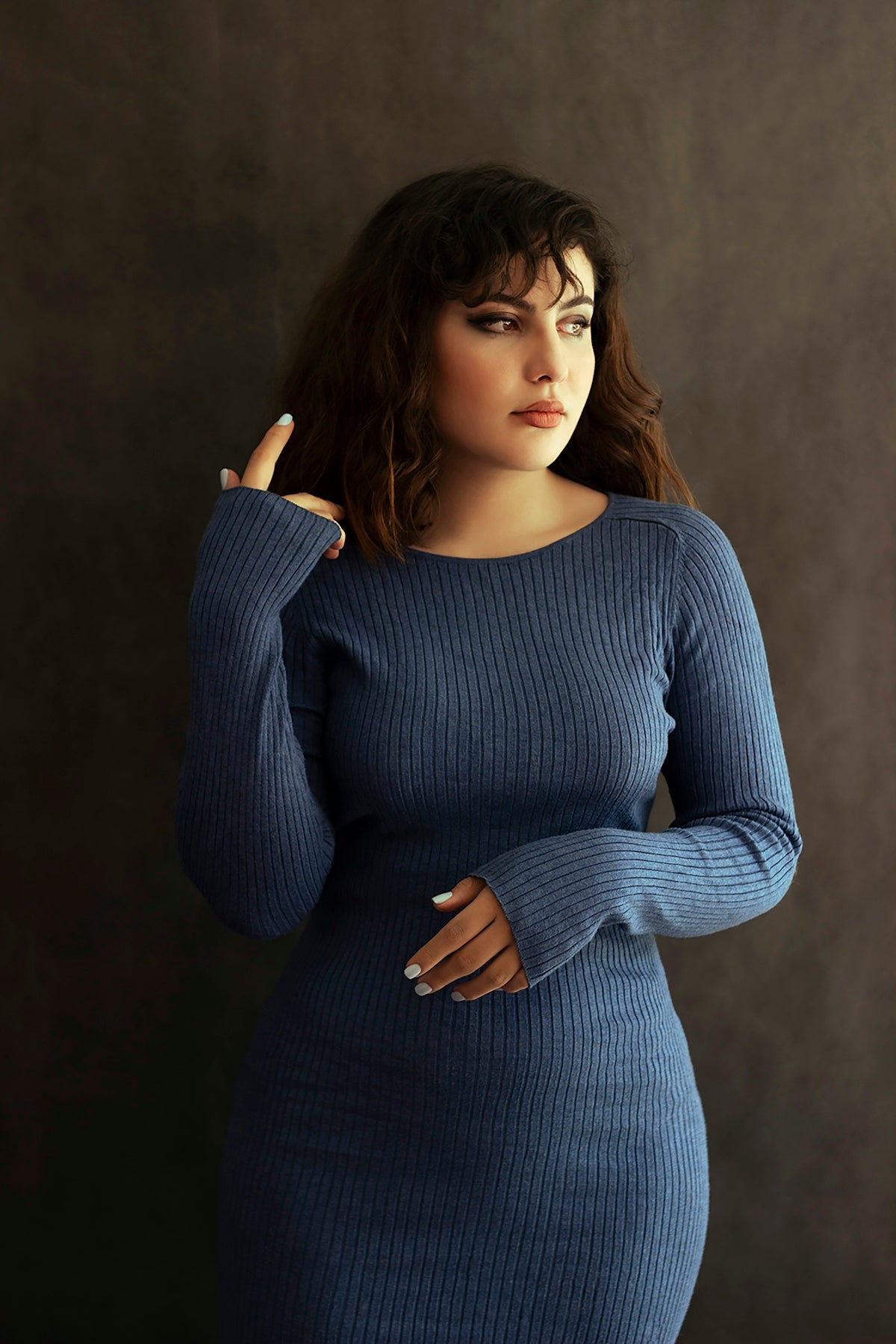 a woman in a blue dress posing for a picture