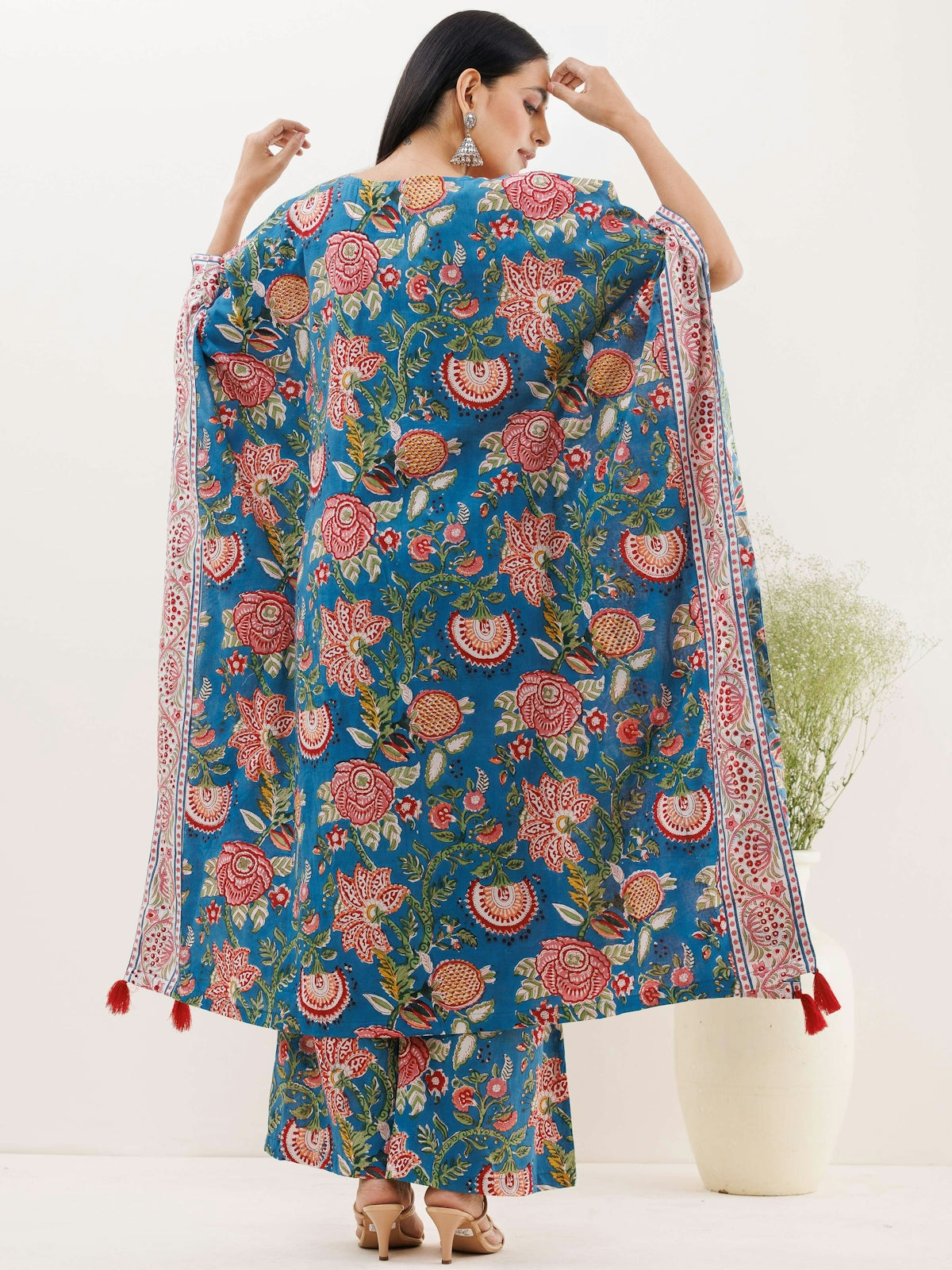 a woman in a blue floral print dress