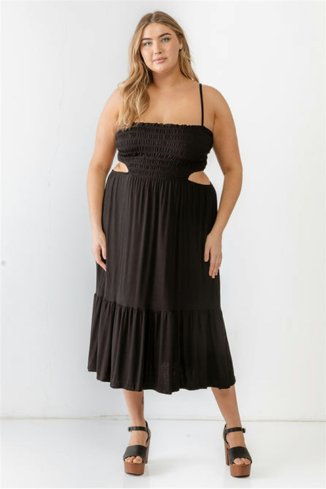 a woman in a black dress posing for a picture