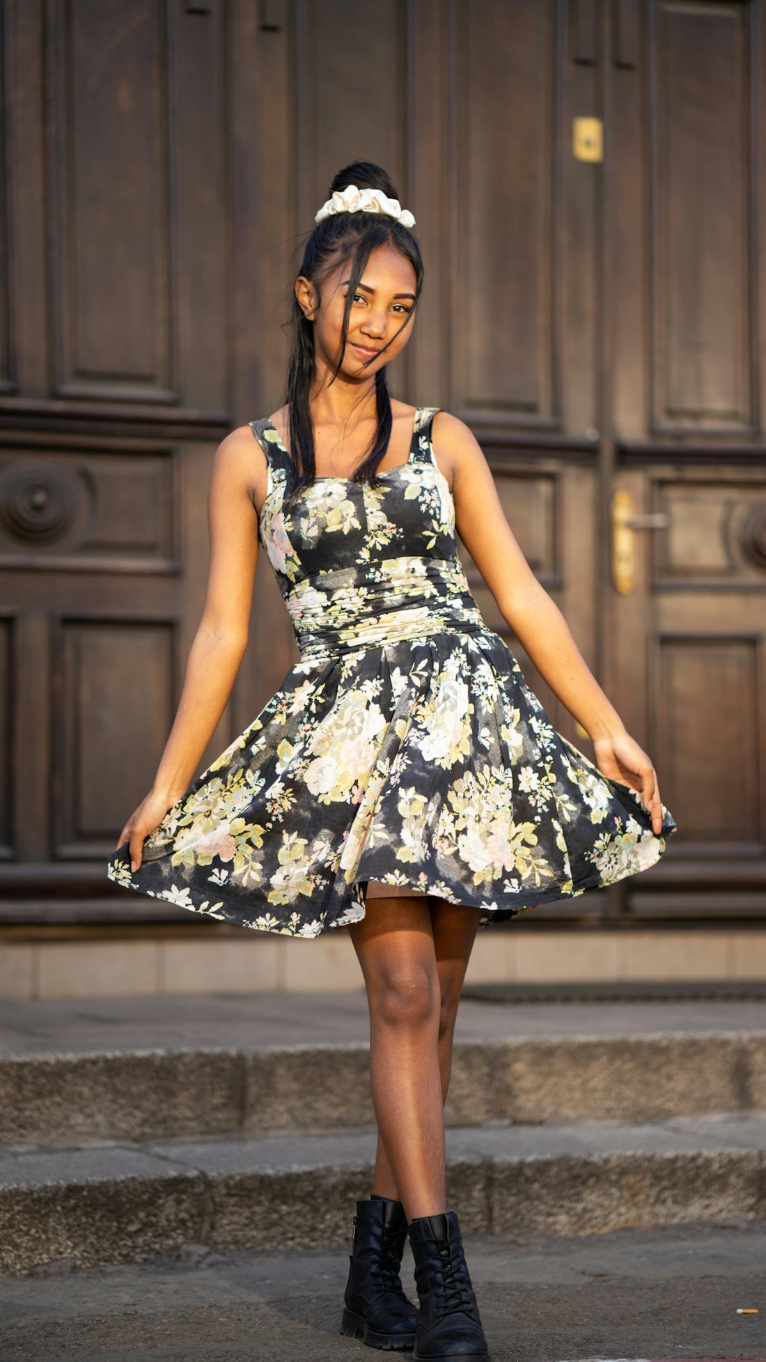 A woman in a dress standing in front of a door