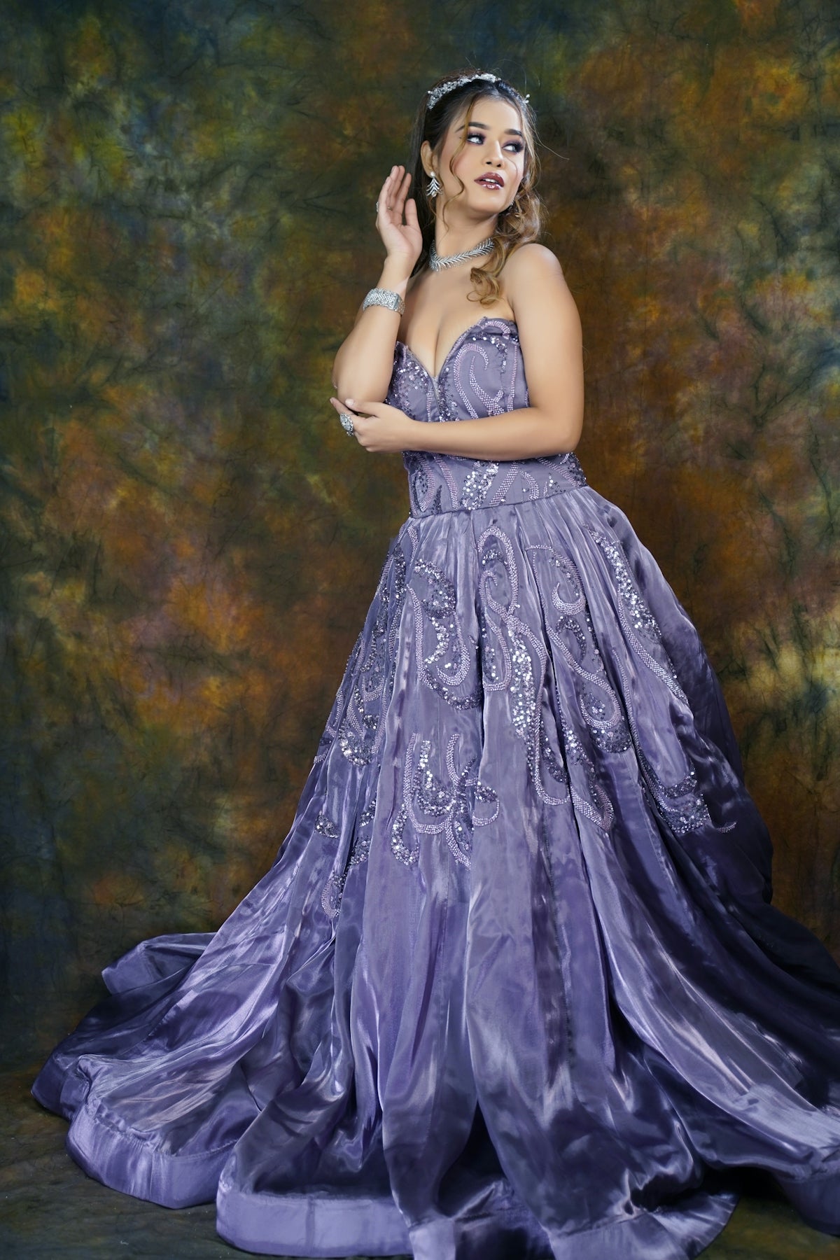 A woman in a purple dress posing for a picture