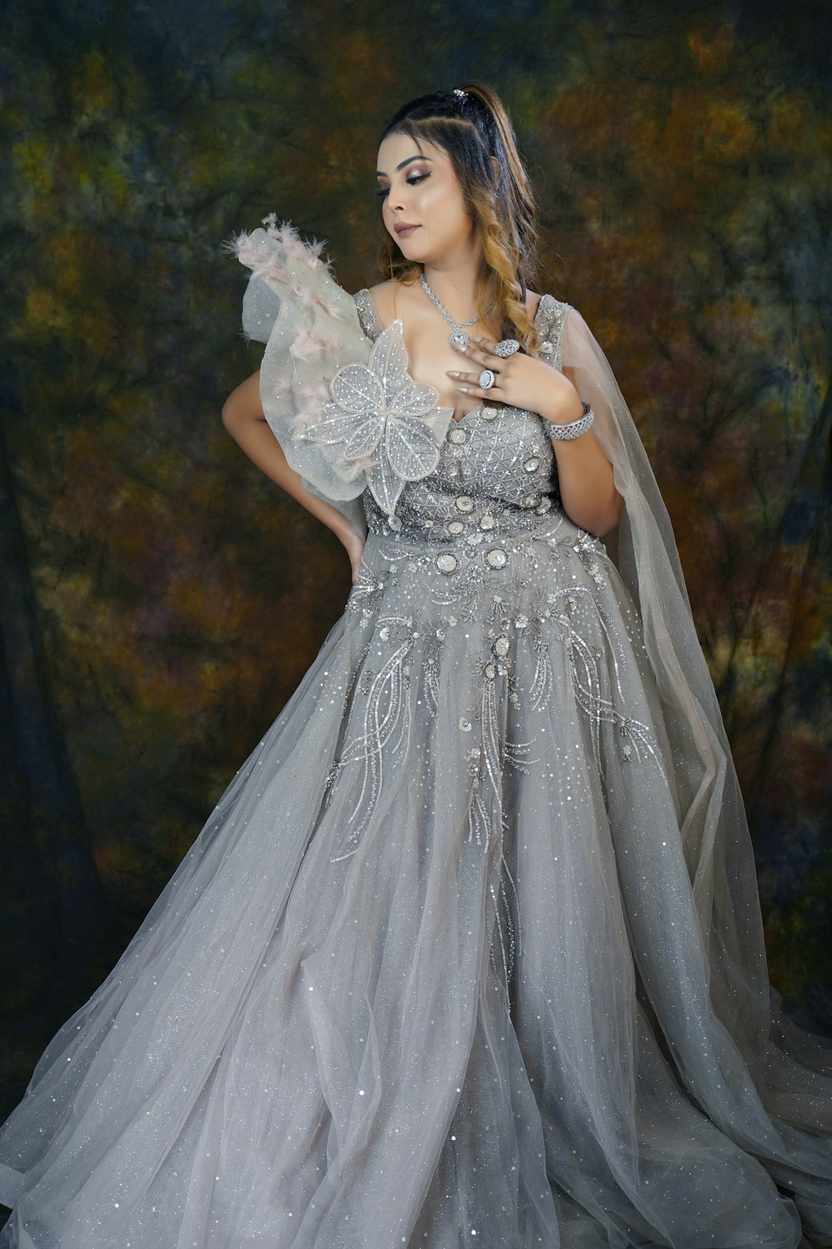 A woman in a wedding dress posing for a picture