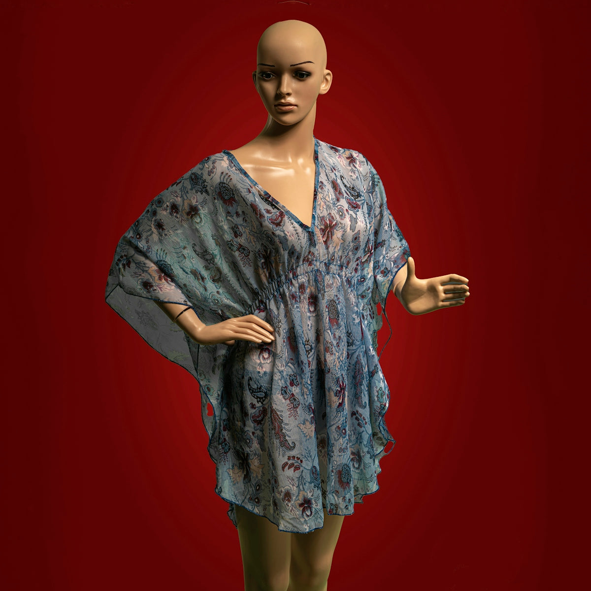 A female mannequin wearing a blue dress and green tights